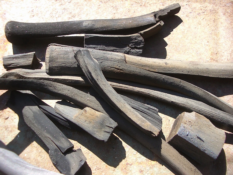 Making blacksmithing charcoal by hand.